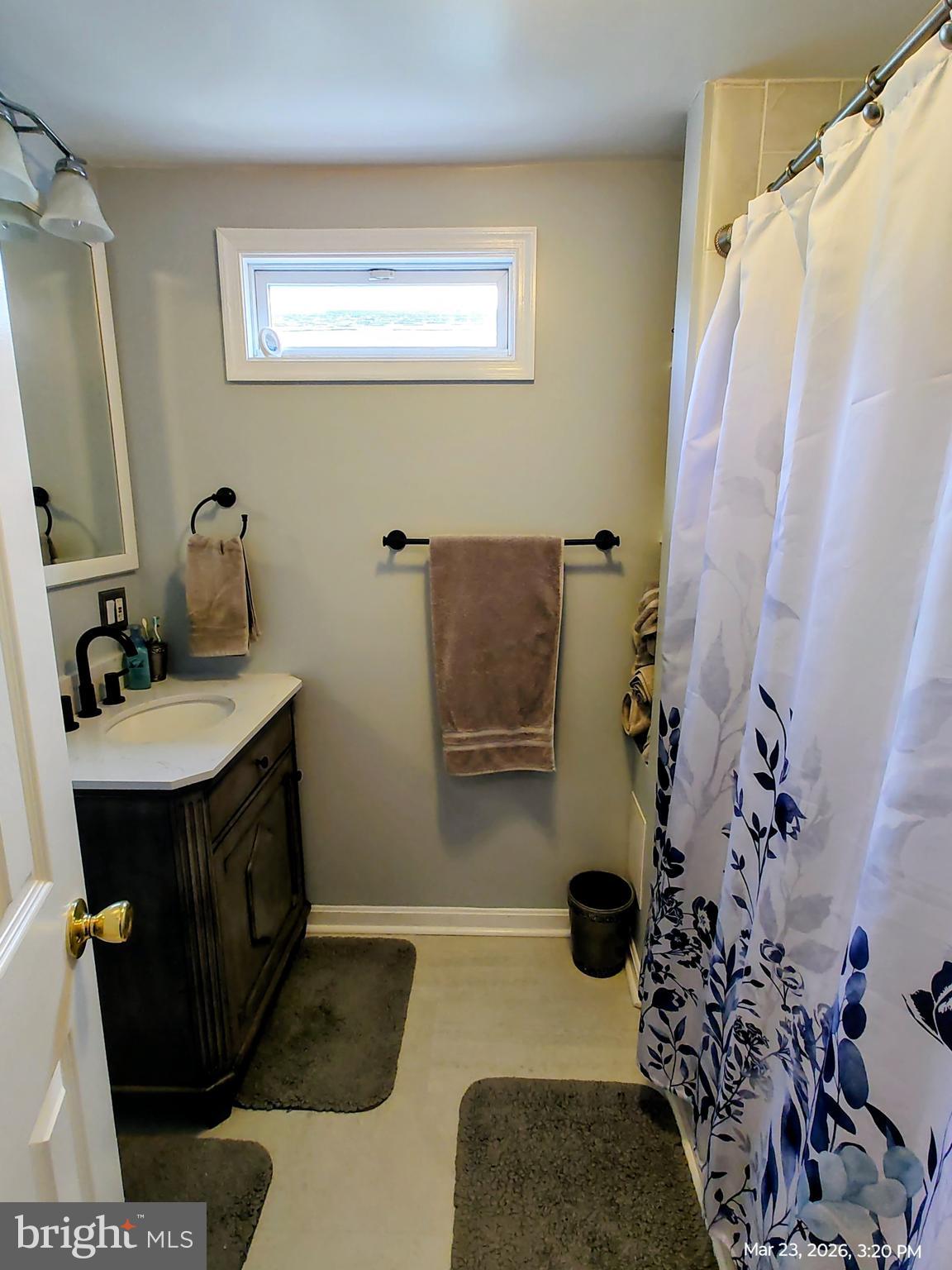 4728 Bucks School House Road Baltimore, MD 21237 - Photo 33 of 64 a bathroom with a sink and mirror with bathtub