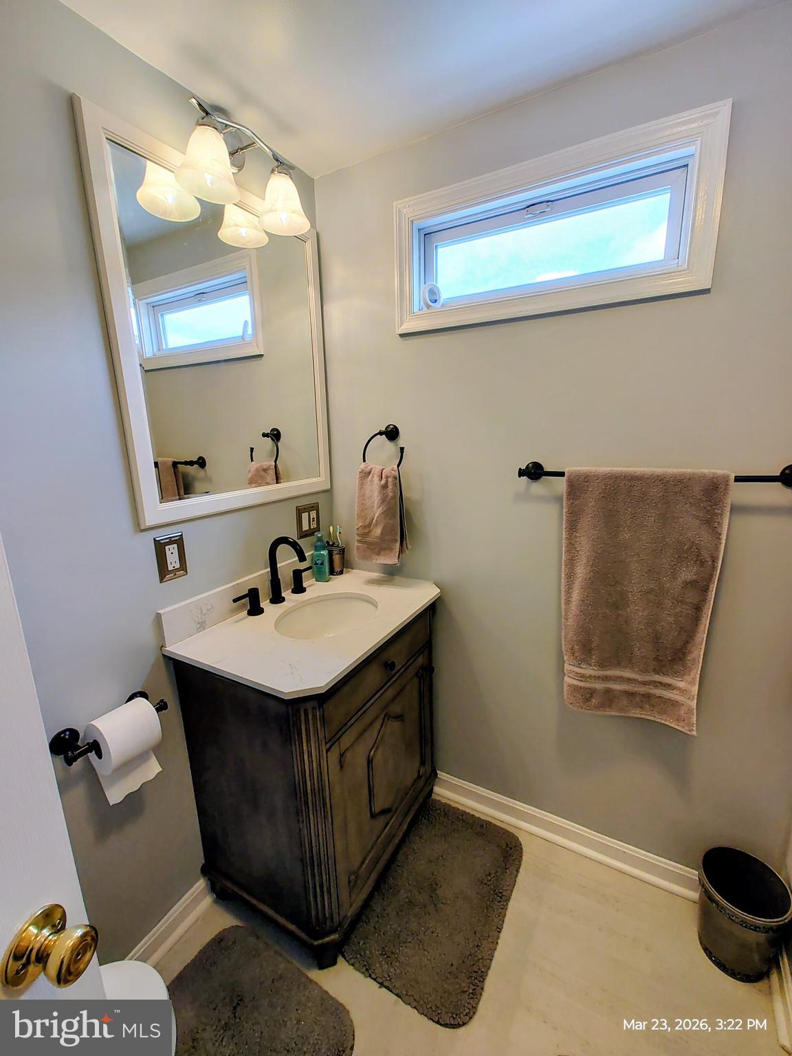 4728 Bucks School House Road Baltimore, MD 21237 - Photo 36 of 64 a bathroom with a sink and a mirror