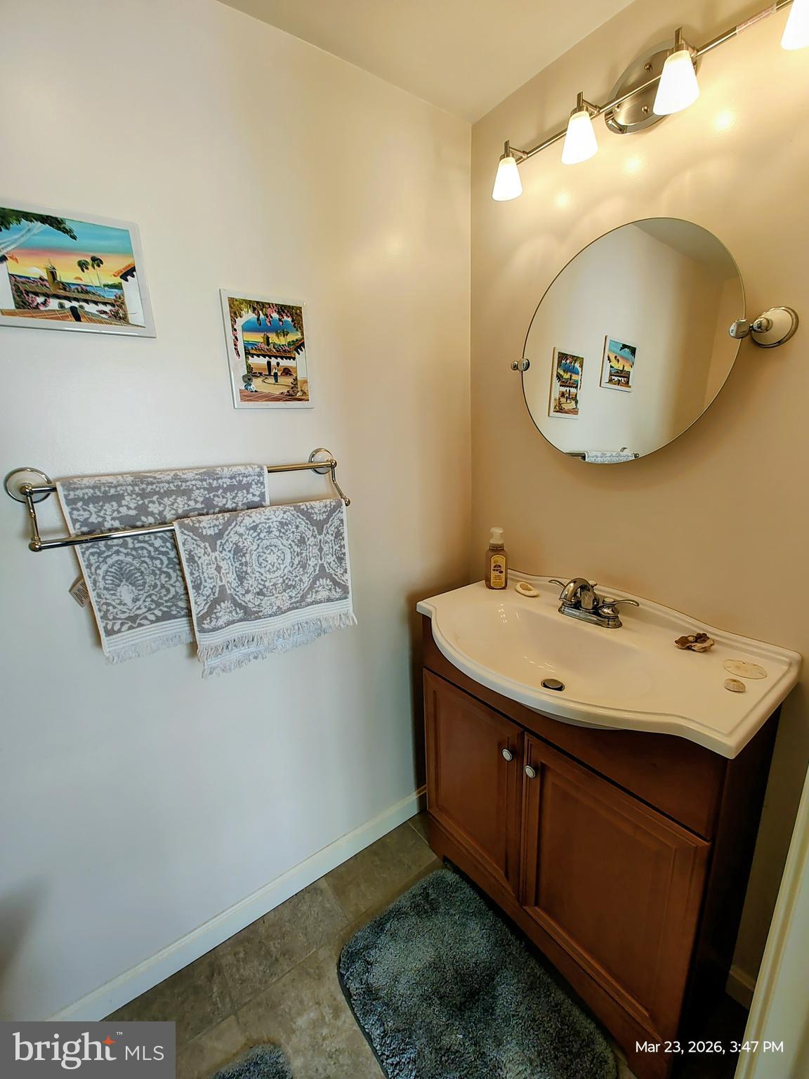4728 Bucks School House Road Baltimore, MD 21237 - Photo 50 of 64 a bathroom with a sink mirror and vanity