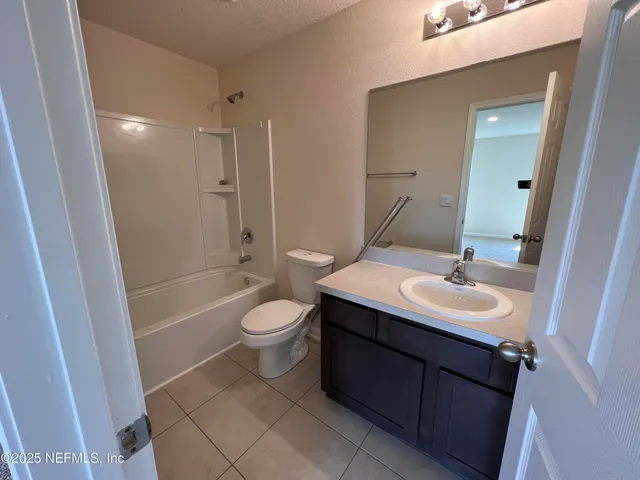 a bathroom with a sink toilet a mirror and shower