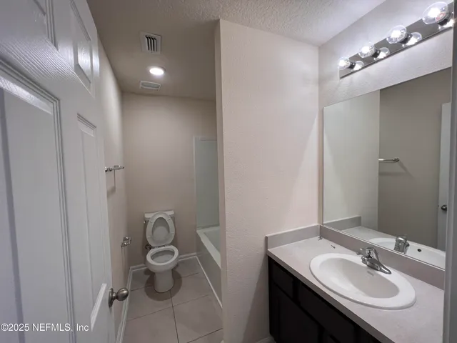 a bathroom with a sink double vanity and a mirror