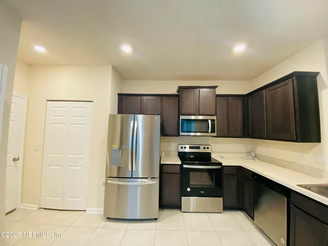 a kitchen with a refrigerator and a sink