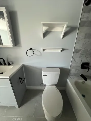 a bathroom with a sink toilet and mirror