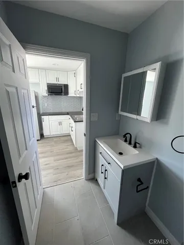 a kitchen with stainless steel appliances granite countertop a sink and a stove