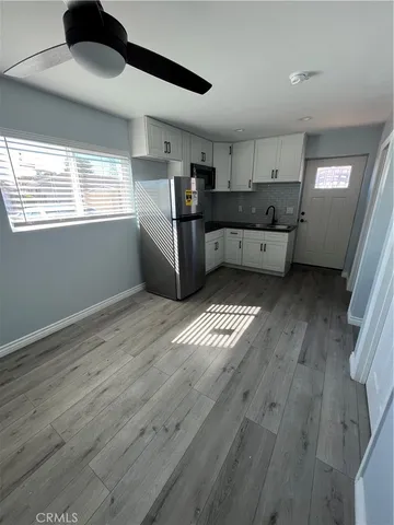a kitchen with stainless steel appliances a refrigerator sink and cabinets