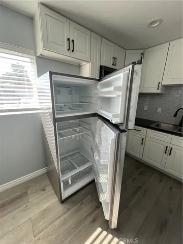 a bathroom with a double vanity sink toilet and shower