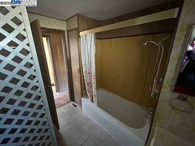 a bathroom with a glass door shower and a sink