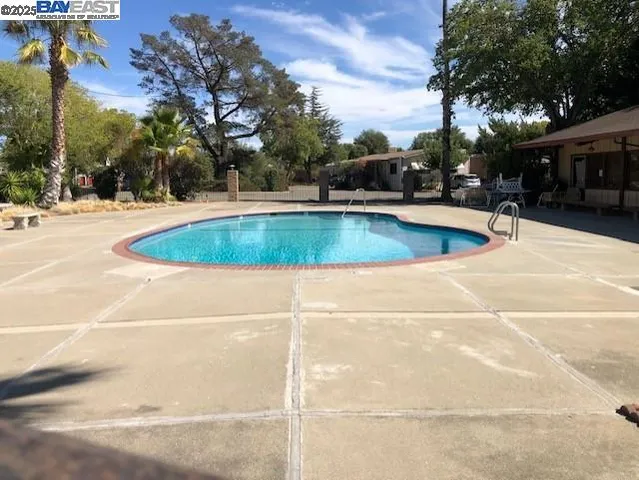 a view of a swimming pool with a patio
