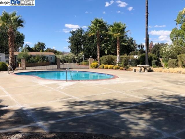 1382 Vía Deste, Unit 61 Livermore, CA 94551 - Photo 20 of 21 a view of a swimming pool with a lawn chairs