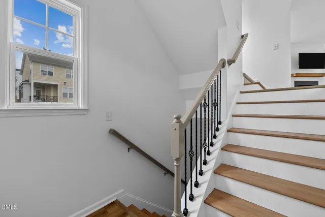 a view of entryway with wooden floor and a front door