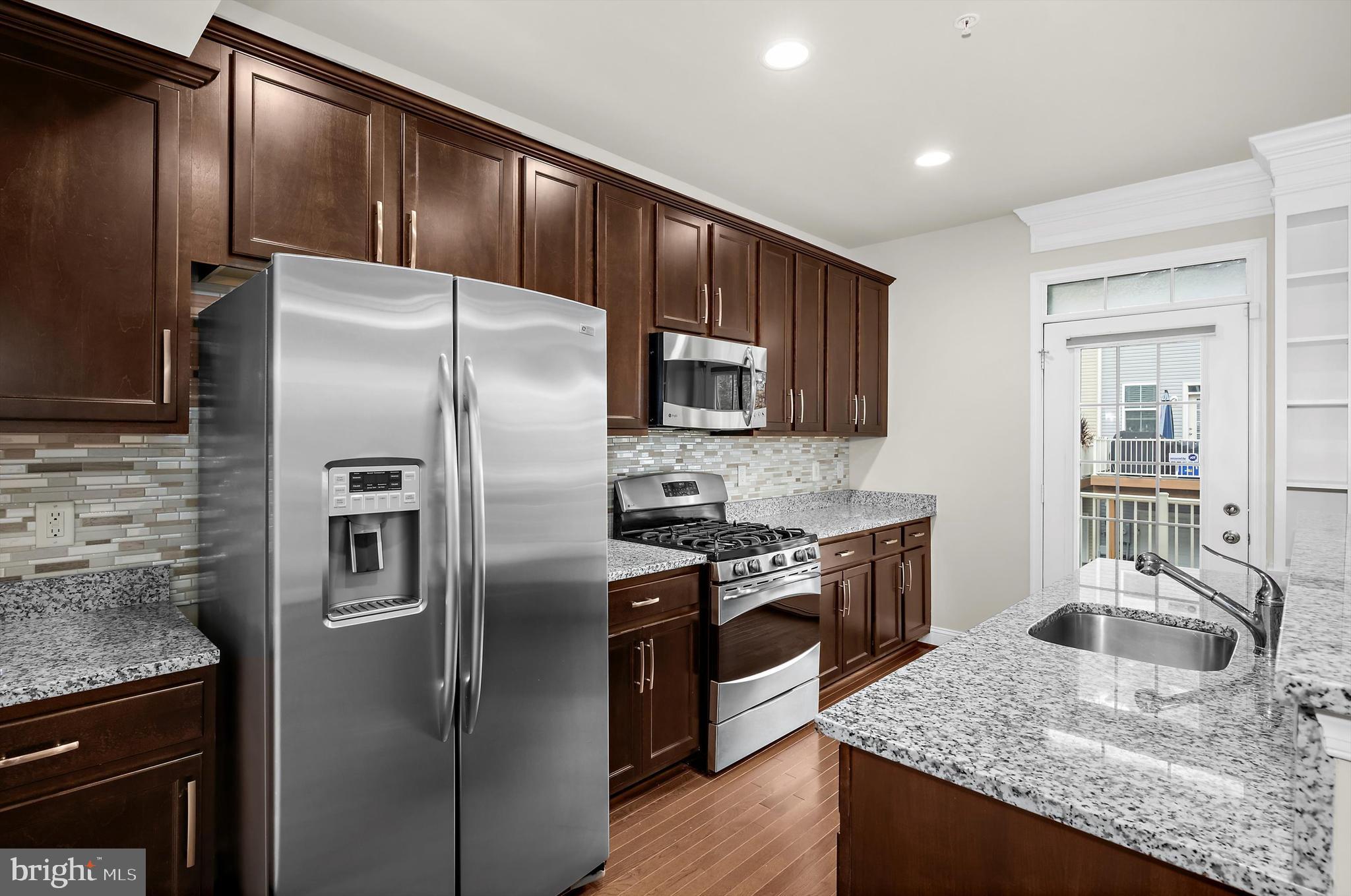 614 South Cherry Grove Avenue Annapolis, MD 21401 - Photo 13 of 40 a kitchen with stainless steel appliances granite countertop a sink stove and refrigerator