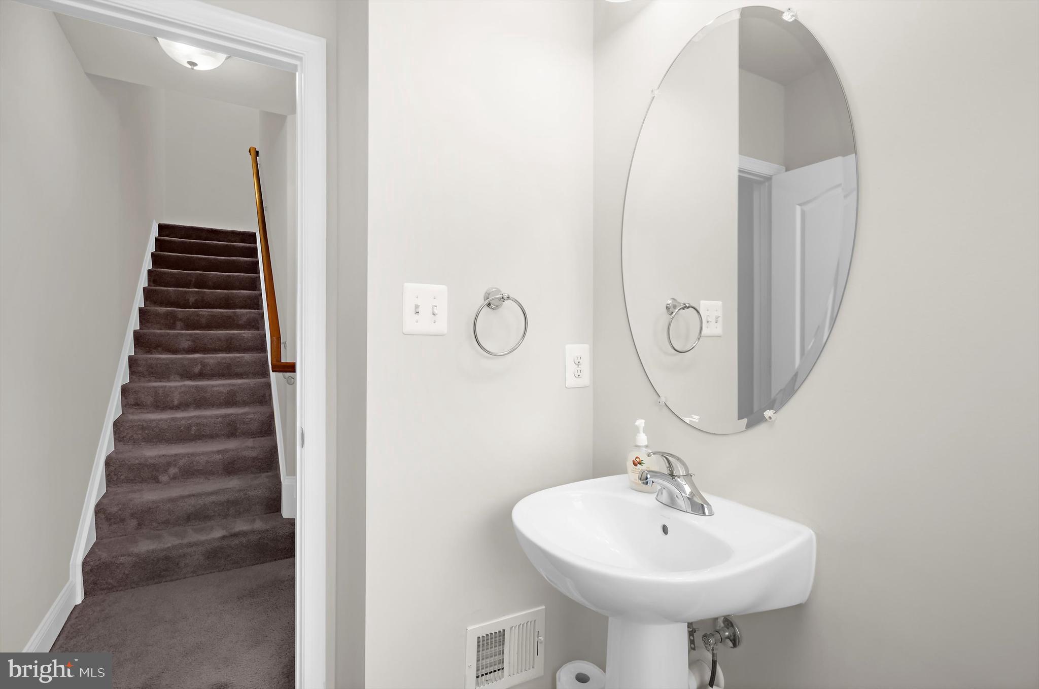 614 South Cherry Grove Avenue Annapolis, MD 21401 - Photo 17 of 40 a bathroom with a sink and a mirror