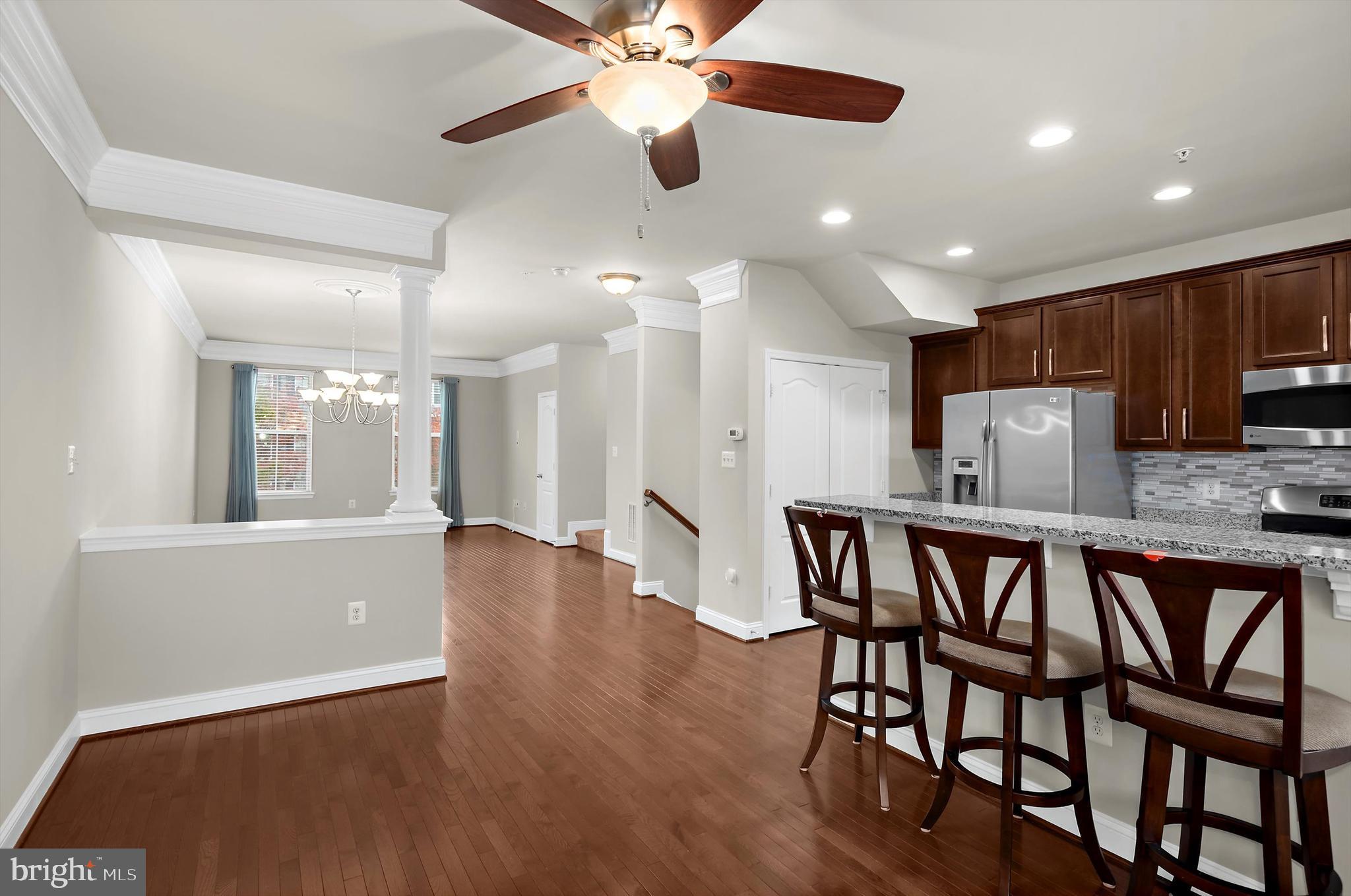 614 South Cherry Grove Avenue Annapolis, MD 21401 - Photo 10 of 40 a kitchen with stainless steel appliances granite countertop a dining table chairs refrigerator and microwave