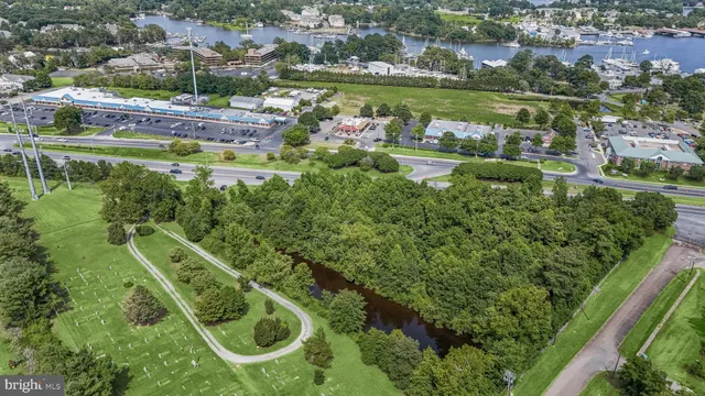 an aerial view of residential houses with outdoor space and swimming pool