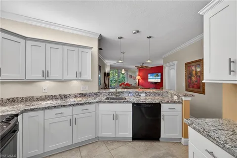 a kitchen with granite countertop a sink and cabinets