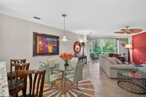 a living room with furniture a rug and a large window
