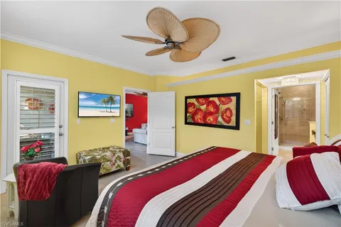 a bedroom with a bed and a large mirror