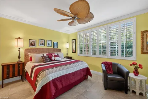 a bedroom with a bed and balcony