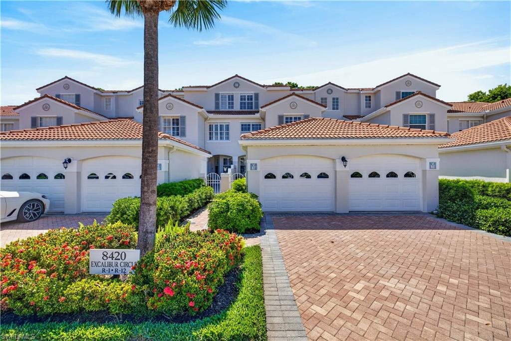 8420 Excalibur Circle, Unit R7 Naples, FL 34108 - Photo 2 of 24 The property features a stucco exterior with a tile roof, an attached garage, and a paver driveway