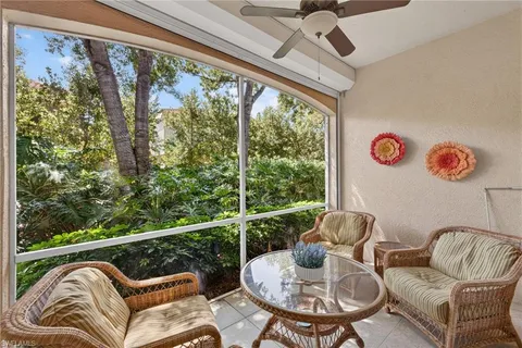 a balcony with table and chairs