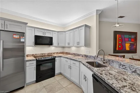 a kitchen with stainless steel appliances granite countertop a sink stove and microwave