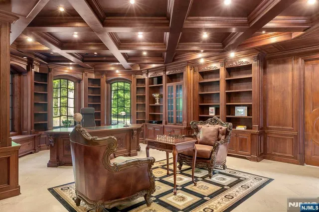 a living room with furniture a flat screen tv and a large window