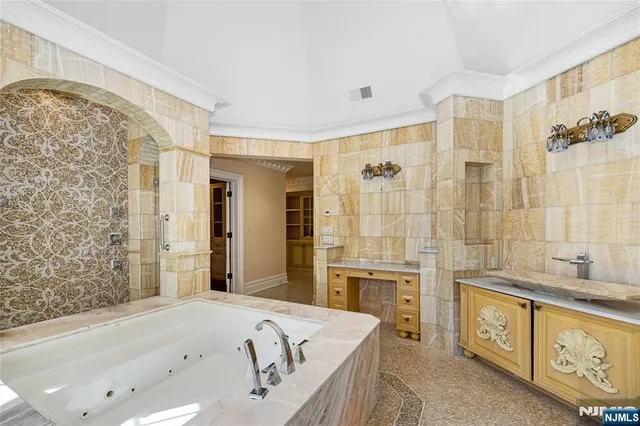 a spacious bathroom with a granite countertop tub sink a mirror a shower and vanity