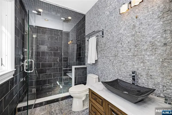 a bathroom with a toilet a sink and shower