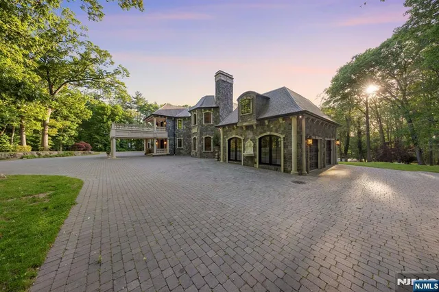 a view of a house with a yard and large trees