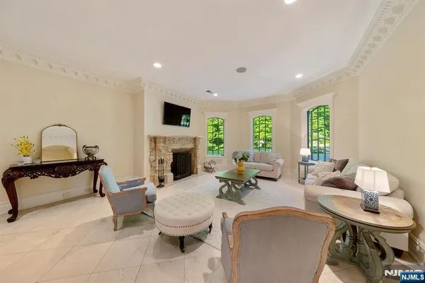 a living room with furniture a fireplace and a flat screen tv