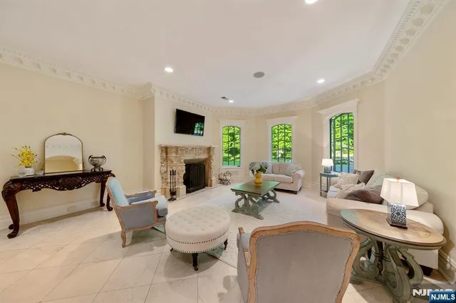 a living room with furniture a fireplace and a flat screen tv