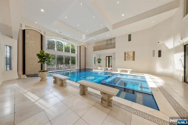 a living room with furniture pool table and chairs