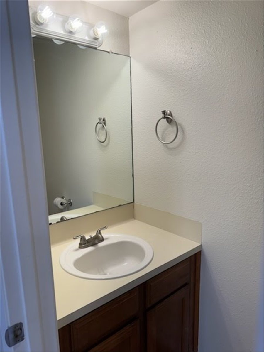 1504 Waterloo Trail, Unit A Austin, TX 78704 - Photo 5 of 12 Bathroom featuring vanity and a textured wall