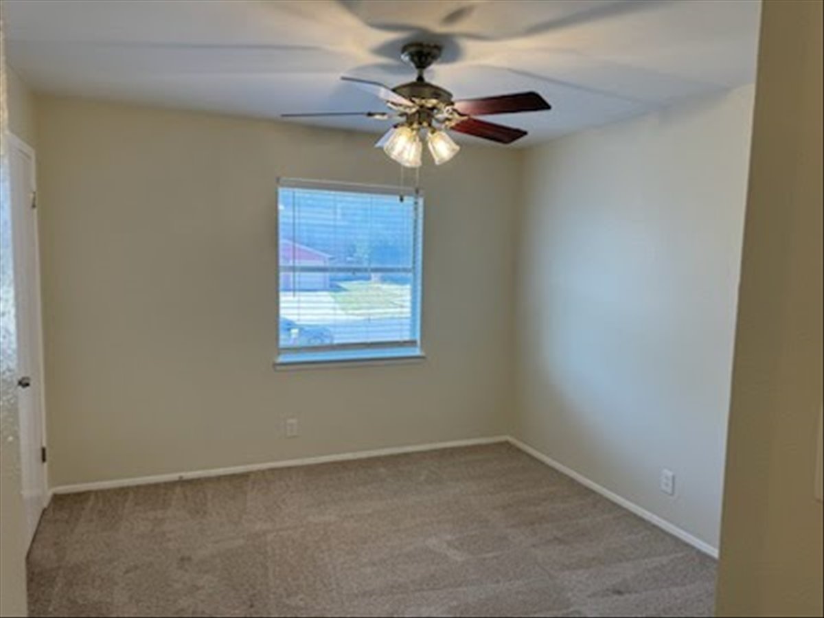 1504 Waterloo Trail, Unit A Austin, TX 78704 - Photo 9 of 12 Unfurnished room featuring light carpet and ceiling fan