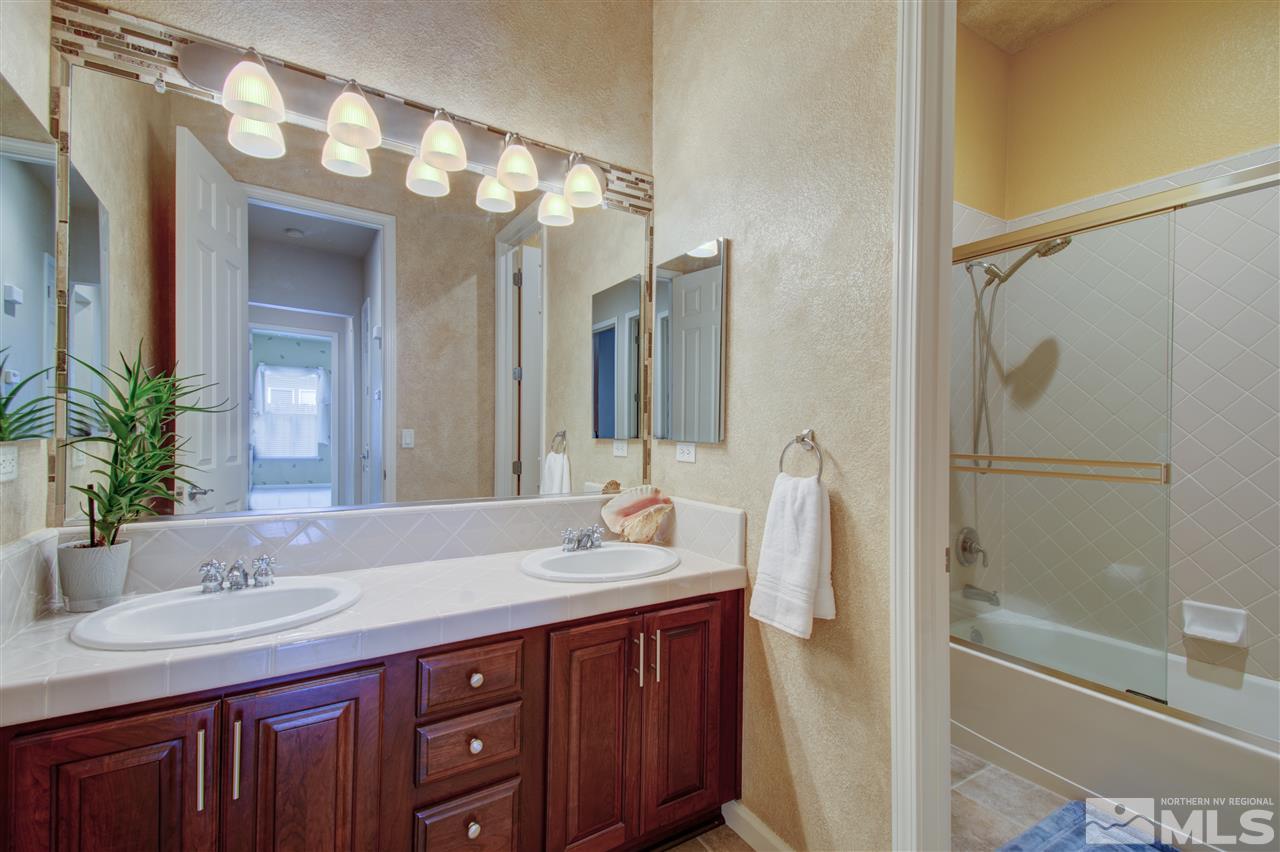 1652 Broadstone Way Reno, NV 89521 - Photo 18 of 25 a bathroom with a double vanity sink and mirror with shower