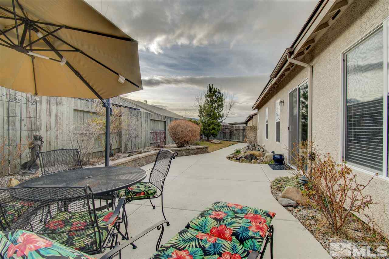 1652 Broadstone Way Reno, NV 89521 - Photo 7 of 25 a patio with table and chairs and potted plants