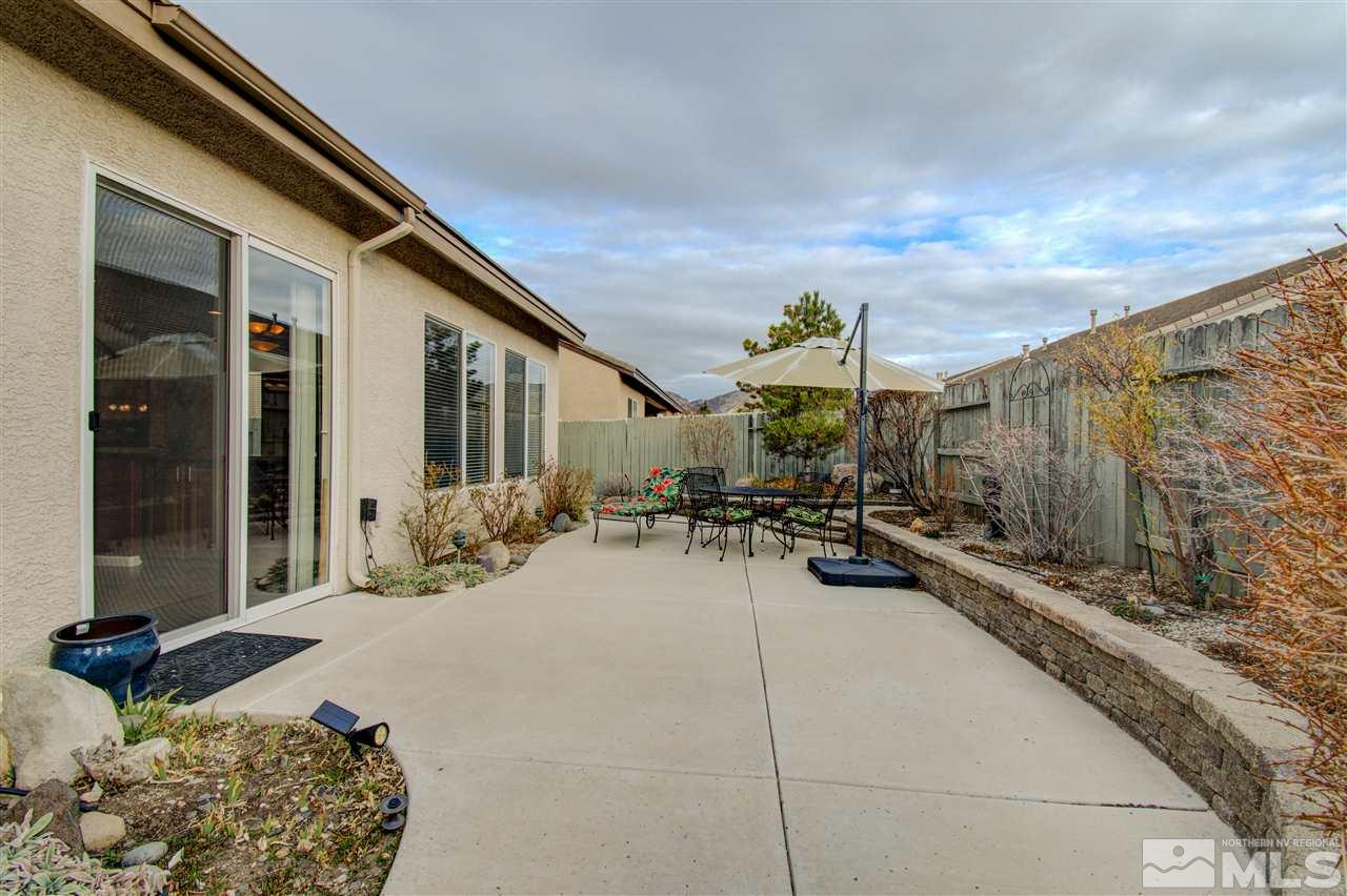 1652 Broadstone Way Reno, NV 89521 - Photo 9 of 25 a view of a patio with couches and table and chairs with wooden fence