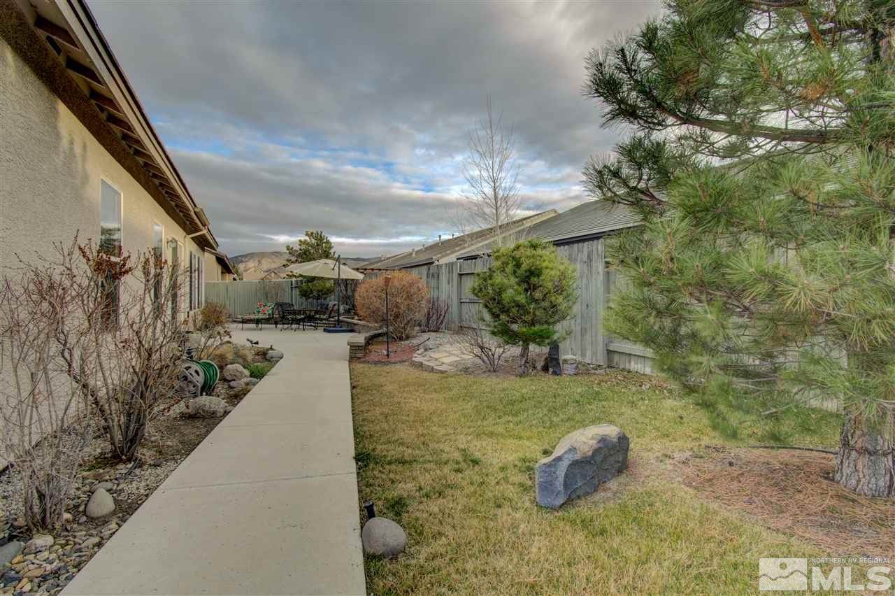 1652 Broadstone Way Reno, NV 89521 - Photo 10 of 25 a view of a backyard with plants and a fountain