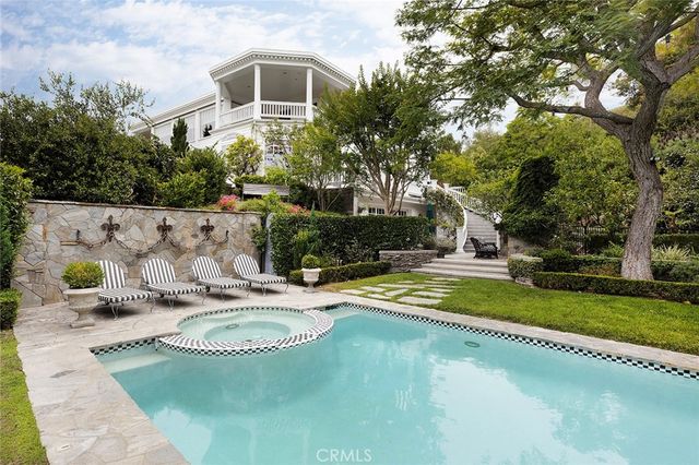 a view of a house with pool and sitting area