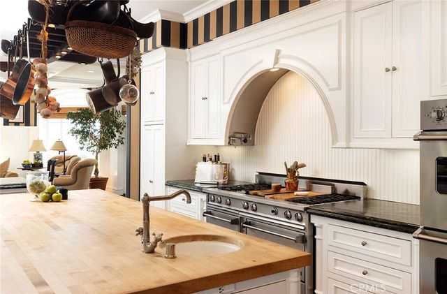 a kitchen with a sink a stove and cabinets