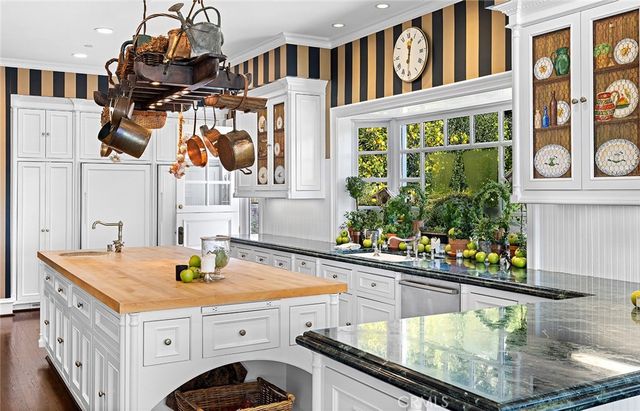 a bathroom with a sink a mirror and painting on the wall