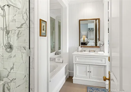 a bathroom with a sink and a mirror with bathtub