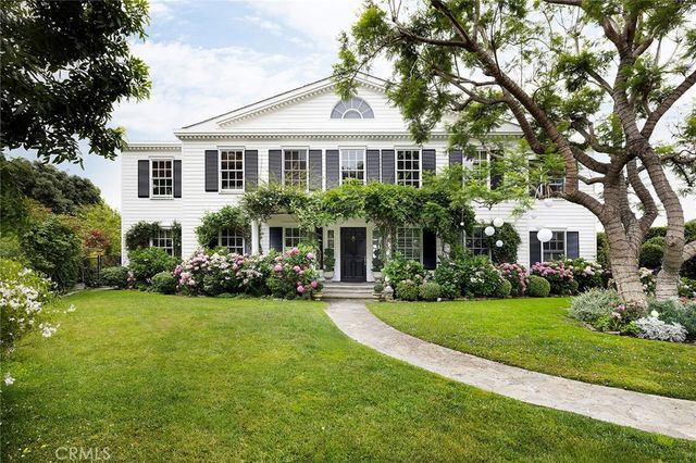 a front view of a house with a yard and porch