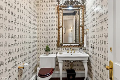 a bathroom with a sink a toilet and a mirror