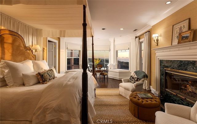 a living room with furniture fireplace and a large window