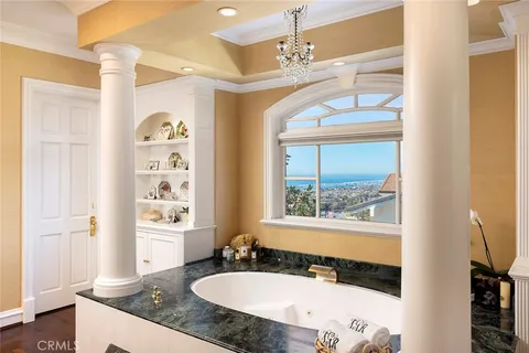 a bathroom with a granite countertop sink window and a mirror