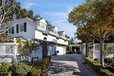 a view of a town with large trees and plants