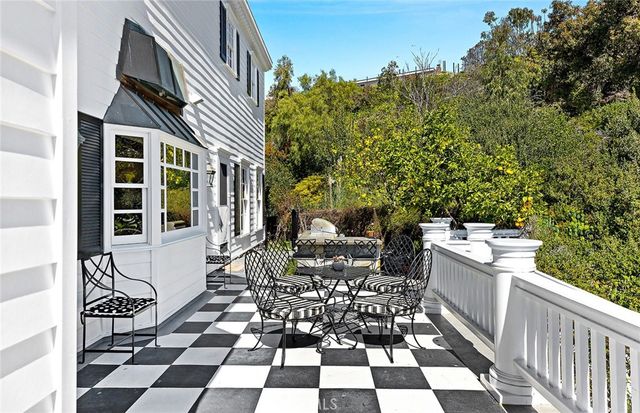 a view of a patio with table and chairs with wooden floor and fence
