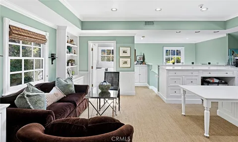 a view of a dining room with furniture and a large window