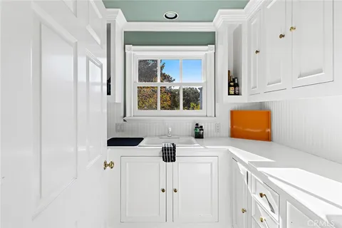 a view of a hallway with workspace and a window